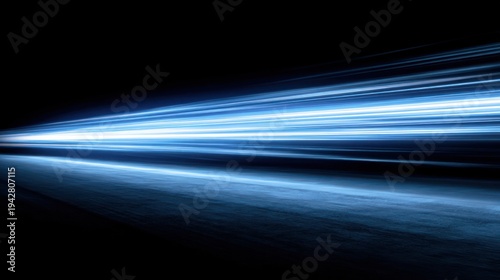 Abstract blue light trails against black background illustrating movement