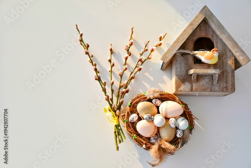 Willow branches and a nest with Easter eggs, a birdhouse. Happy Easter! Glad Påsk! (in Swedish)