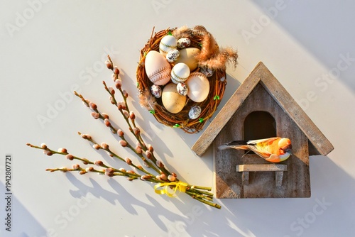 Willow branches and a nest with Easter eggs, a birdhouse. Happy Easter! Glad Påsk! (in Swedish)