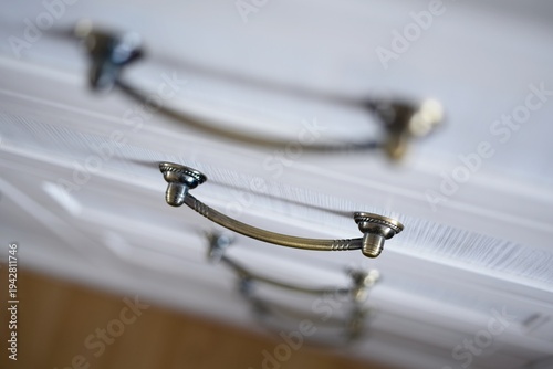 Hot plates on white electric stove close up, there are casserole and pan on hot plates with lids, kitchenware dishes