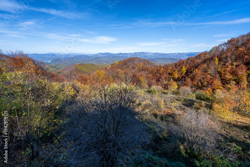 Panoramic scenic landscape with tranquil fall colors. View of a mountain range photographed in autumn. Beautiful autumn colors cover the photo. Suva Planina - Serbia.