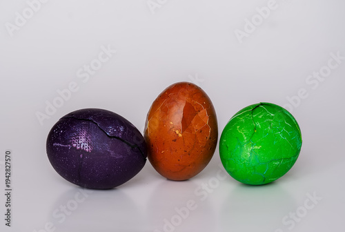 Easter eggs painted in different colors with unusual patterns on a white background, front view