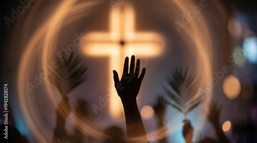 Crowd holding palm leaf with raised hand during christian worship service at church. Blurred glowing cross in background. Religious holiday concept, palm sunday, easter celebration.