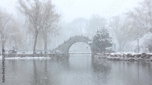 A winter snow scene of a stone bridge
