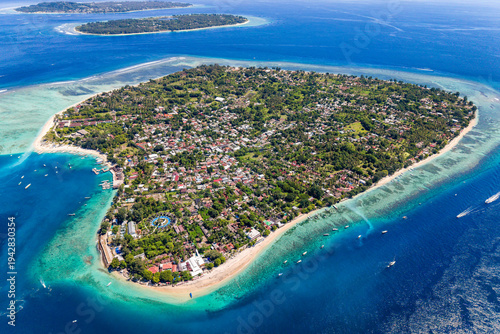 Aerial view of Gili Air island in Indonesia featuring beaches, reefs, and local village