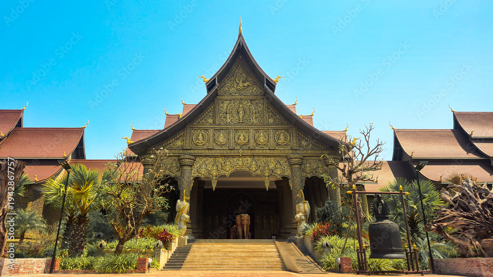 Obraz premium Grand entrance of the Lao Art Museum with intricate wood carvings and elephant statue, Vientiane, Laos 