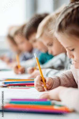 Wallpaper Mural Education training class. Knowledge learning improvement study. A group of children sitting at a table, each holding a pencil and drawing on a piece of paper. Torontodigital.ca
