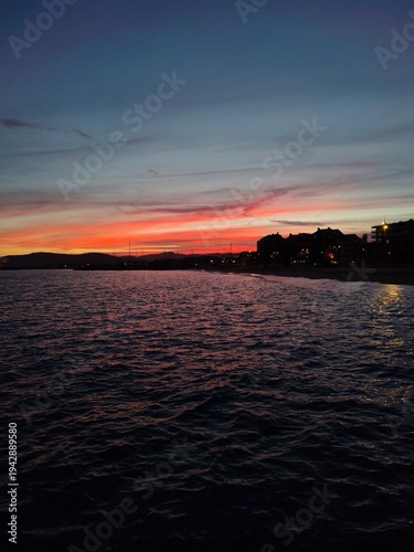Frejus,France-Febrary 18,2026:Amazing red colour sunset view with sea water and waves at beach 