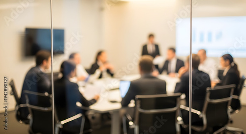 blurred image of business people in a meeting behind a glass wall in a conference room with a project.