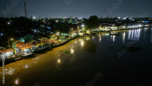 Aerial shot of a green village on the banks of the river in Banjarmasin, South Kalimantan in the night