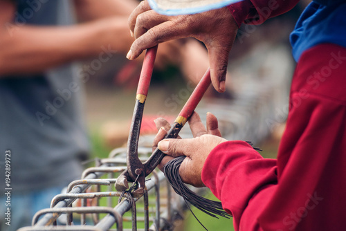 Quadro em tela Construction Worker hands using pincer pliers iron wire
