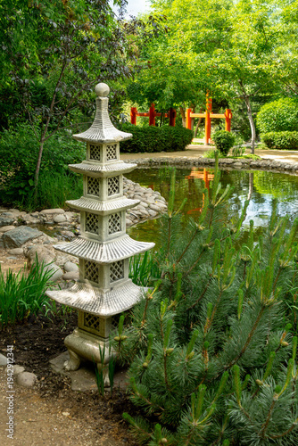 Decorative garden pagoda in the summer garden next to the pond