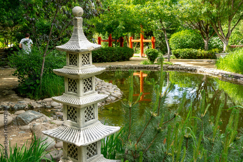 Decorative garden pagoda in the summer garden next to the pond