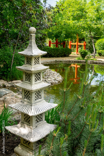 Decorative garden pagoda in the summer garden next to the pond