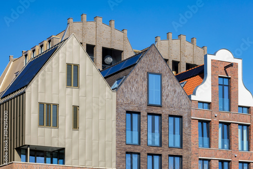 Newly built contemporary canal houses in front of a blue sky in Zwolle, The Netherlands