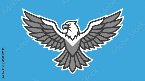 Majestic eagle soaring with outstretched wings against a blue backdrop.