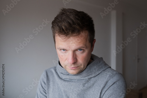 Mid Shot Emotional Portrait of a Middle Aged Man Looking Reproachfully at the Camera