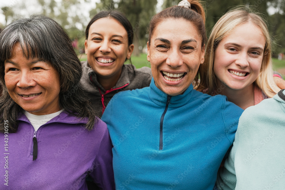 Fototapeta premium Group of multiracial women with different age and body having fun together at city park - Multi generational people, yoga class and female community concept - Main focus on center latin woman face