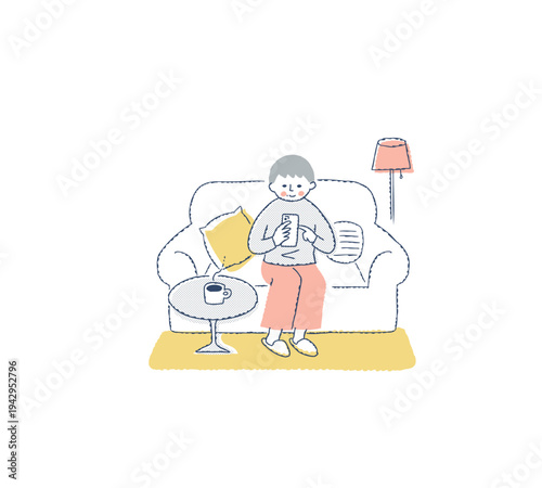 ソファに座ってスマホを操作する女性　