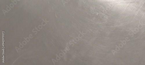 Stainless steel surface that has been worn and scratched.