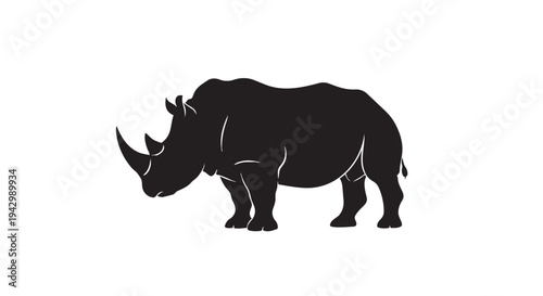 Powerful rhinoceros profile silhouette with a large horn stands solidly on a plain white background for conceptual graphics.