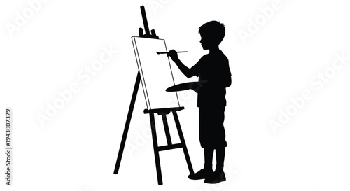 Young artist painting at an easel a striking black silhouette