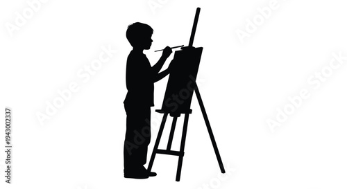 Young artist painting at an easel a striking black silhouette