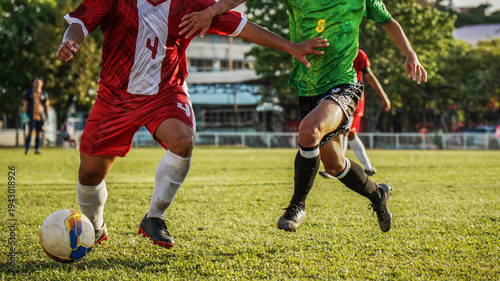 Professional soccer match at golden hour, focus on player's legs and the ball