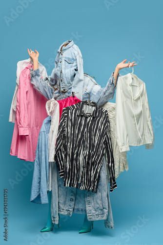 Photos Fashion shopping overload with woman hidden behind hanging clothes for retail advertising, clothing store marketing, wardrobe styling concepts and fashion promotion campaigns