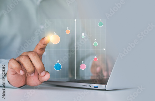 Business market positioning analysis, scatter matrix chart on digital interface laptop, finger selecting data point, competitive analysis, product positioning strategy, market research visualization