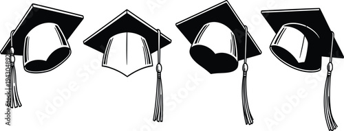 Four graduation caps with tassels in a row