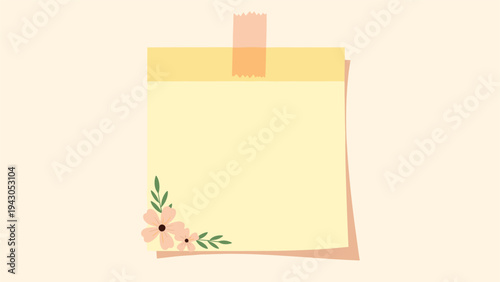 Blank yellow sticky note with a delicate floral decoration, securely taped to a light background, perfect for reminders, messages, or creative thoughts.
