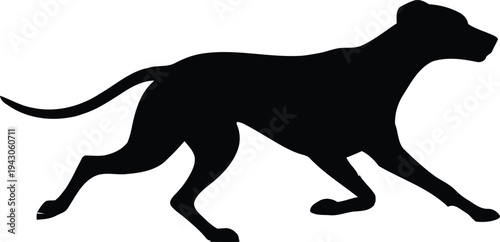 Black silhouette of a dog in motion running or walking quickly