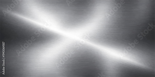 A polished silver brushed metal texture background features a shiny stainless steel surface with a light grey metallic pattern and industrial aluminum material reflections