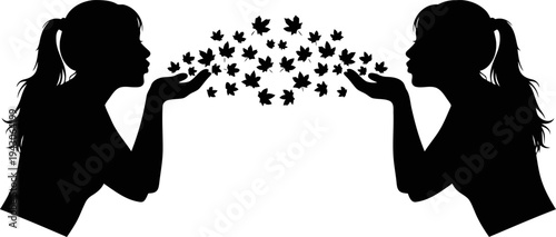 Black and white silhouette of person blowing leaves in wind