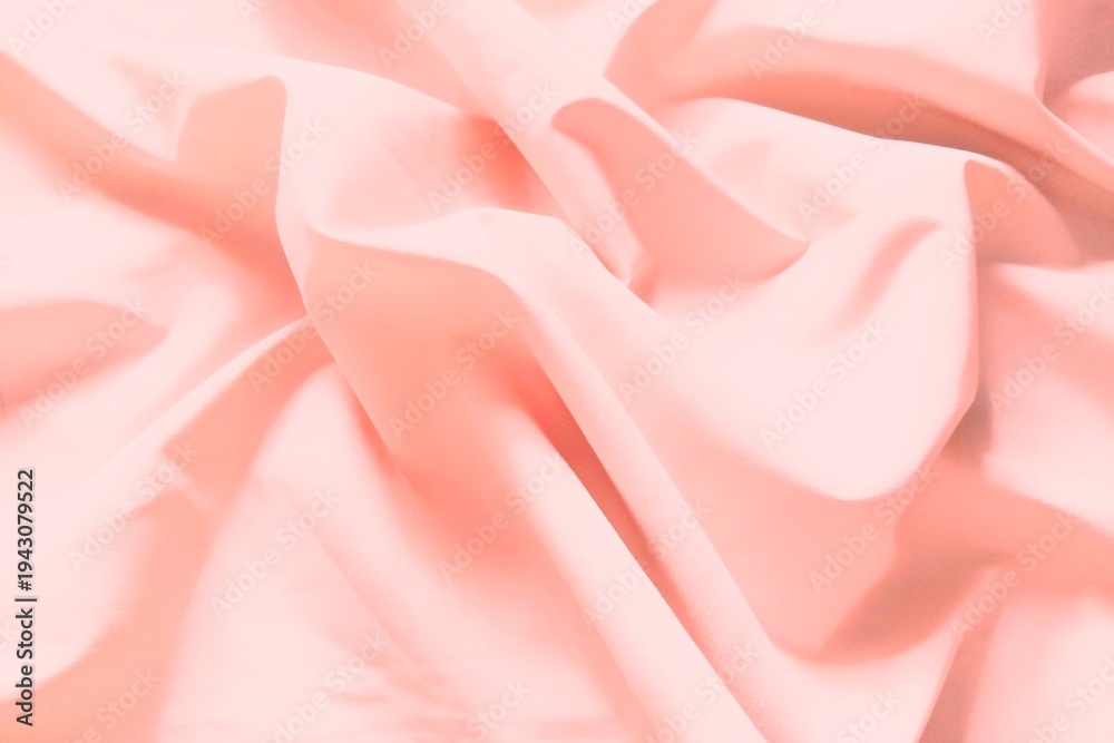 Obraz premium ​Soft pink crumpled fabric texture, elegant aesthetic pastel silk background.