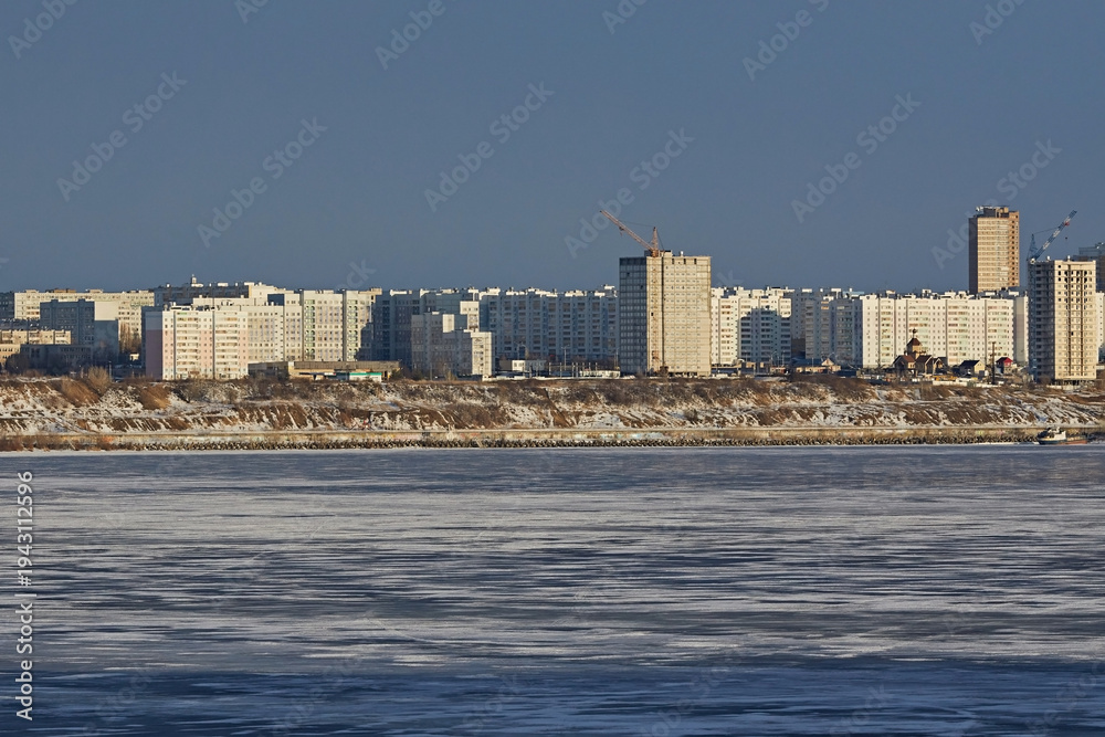 Naklejka premium City embankment with a frozen river