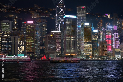 Hong Kong cityscape with Victoria Harbour. Night city skyline view from Kowloon Tsim Sha Tsui waterfront in direction of Central Hong Kong.