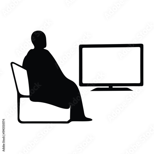 Silhouette of a person sitting on a chair watching a television screen