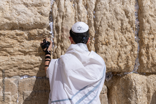 Jewish teenager praying at the Western wall in Jerusalem