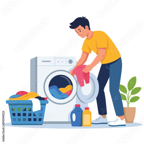 Young man putting clothes into the washing machine