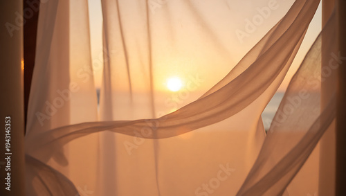 Soft curtains flowing in the breeze with sunset view outside  