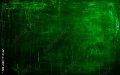 Dark green decorative abstract background. Texture of plastered concrete wall. Grunge background. The combination of the texture of a grainy rough surface and dark turquoise color