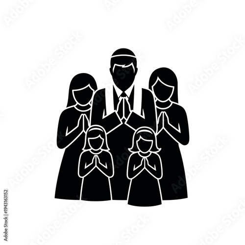 Family praying together in silhouette.