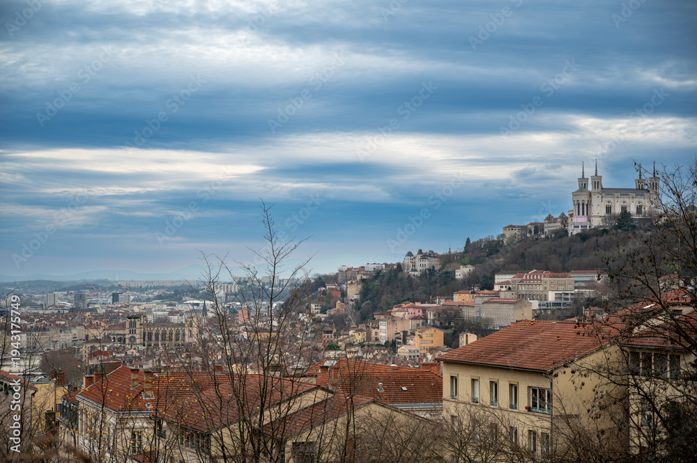 Obraz premium Lyon, france. December 28, 2023. Lyon city panorama during the day, showing the basilique notre-dame de fourvière and surrounding rooftops under a cloudy sky