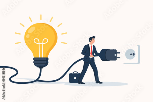 Businessman holding large electrical plug connected to glowing light bulb about to plug into wall socket. Concept of creative business idea, innovation, power, energy, and project execution.