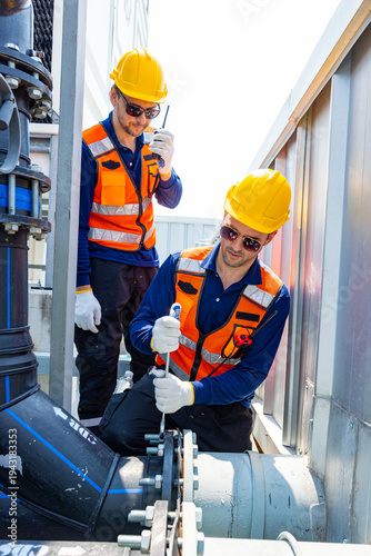 Industrial Technicians Adjusting Large Pipeline Valve