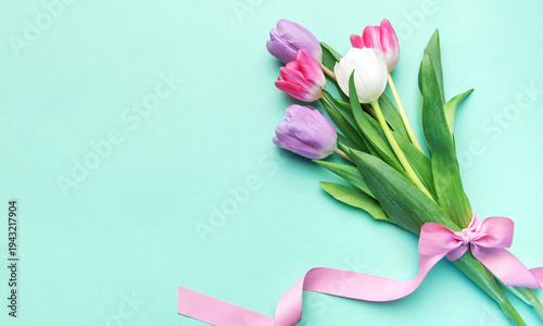 Tulips bouquet with pink ribbon on mint background
