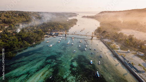 Drone view of a bridge between two islands over a narrow ocean channel. Nusa Lembongan and Nusa Ceningan bridge.