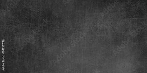 Vintage dark grunge texture with a rough black and white pattern on an old weathered surface creates a blank grey wall backdrop for a dirty industrial design